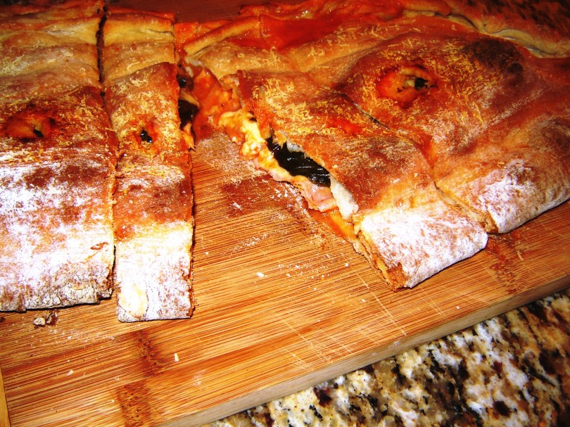 Finished and ready to serve homemade calzone with fresh mozzarella, prosciutto cotto and fontina cheese from Paggi Pazzo