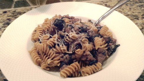 Ground sausage cooked in a garlic and white wine sauce with spinach over rotini pasta and Pecorion Romano from Paggi Pazzo!