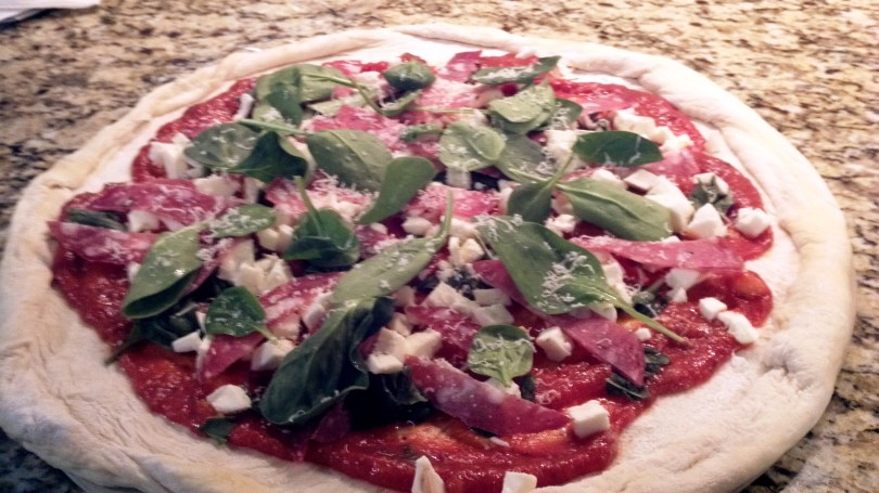 Tuscan style pizza prepared with salame Toscano, Pecorino Toscano, spinach, fresh mozzarella, and mushrooms from Paggi Pazzo!