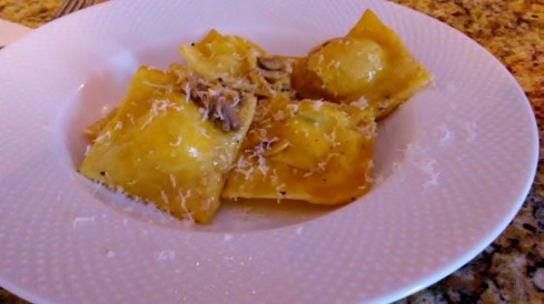 Homemade speck fresh ricotta, spinach and sun-dried tomato ravioli in white wine, garlic and mushroom sauce from Paggi Pazzo